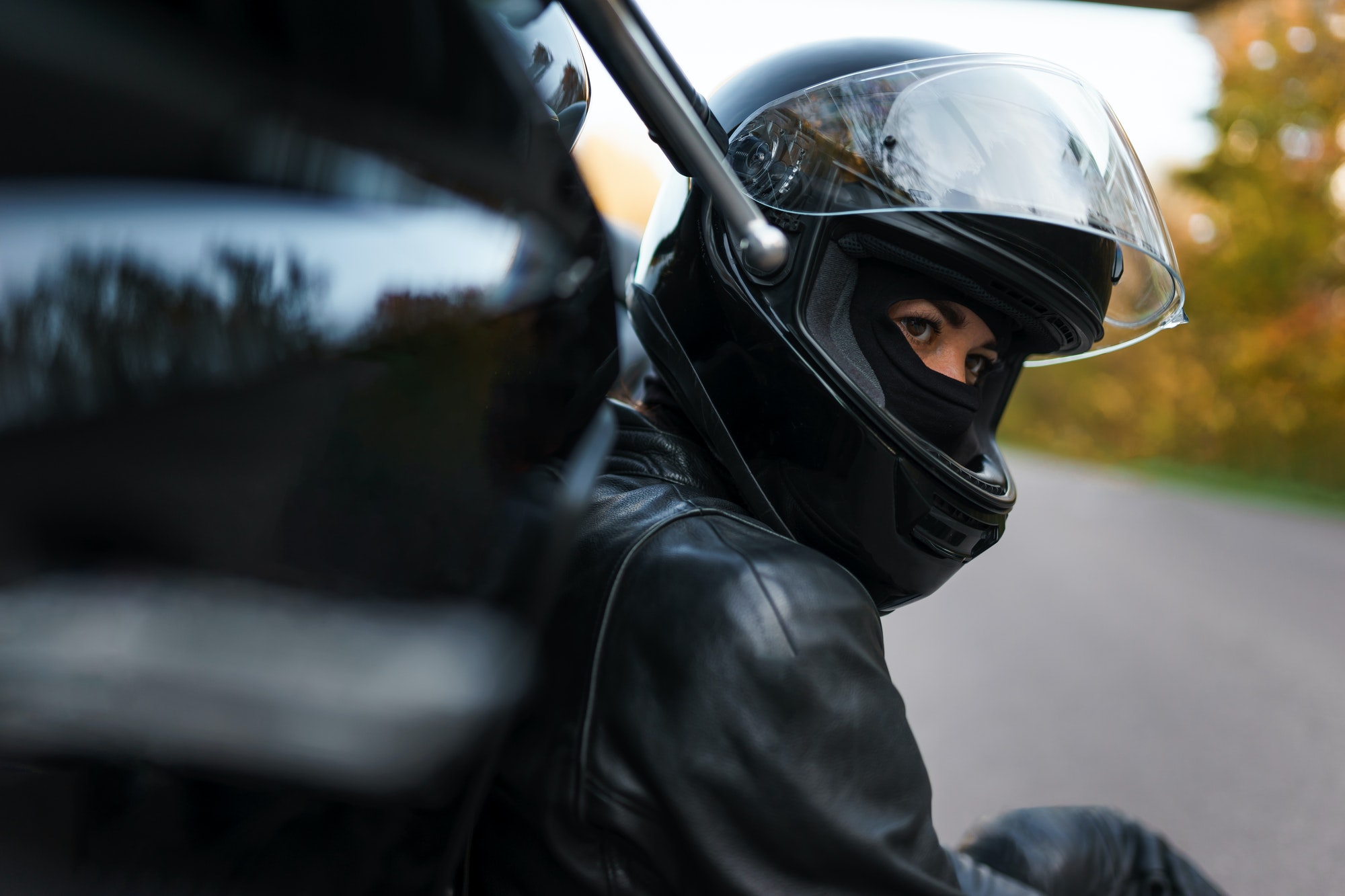 Portrait of serious girl biker in helmet