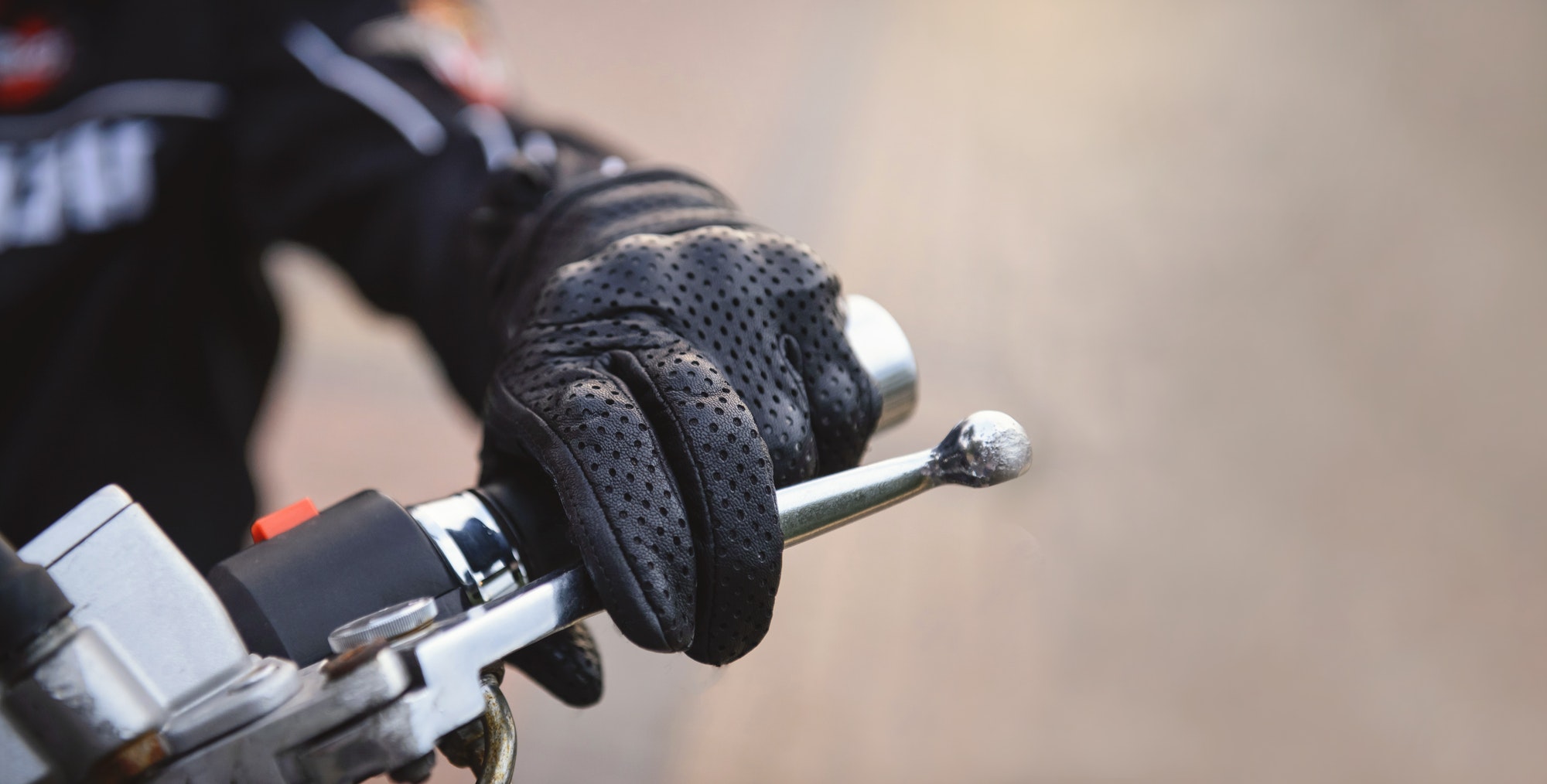 protective biker gloves on a motorcycle wheel